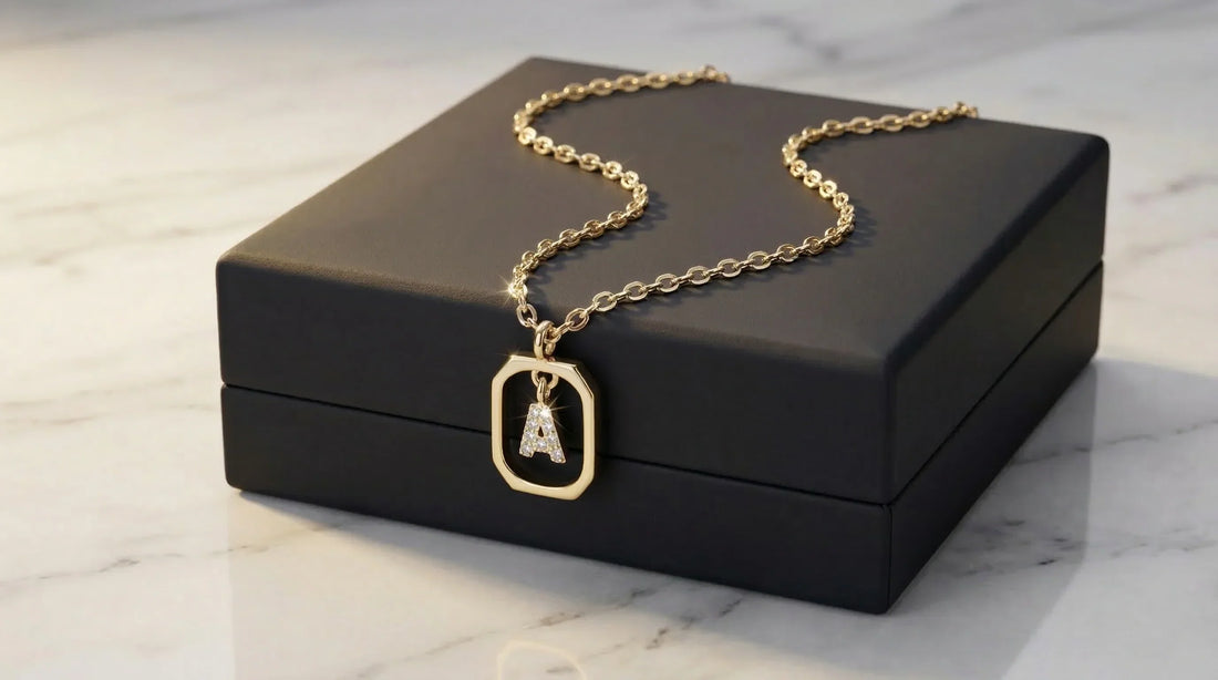A beautiful 925 sterling silver initial necklace resting on a premium dark charcoal gift box.