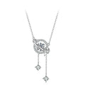 A sterling silver necklace with a celestial pendant featuring a central clear gemstone, surrounded by a ring of small clear stones, with two dangling star-shaped charms.