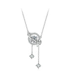 A sterling silver necklace with a celestial pendant featuring a central clear gemstone, surrounded by a ring of small clear stones, with two dangling star-shaped charms.
