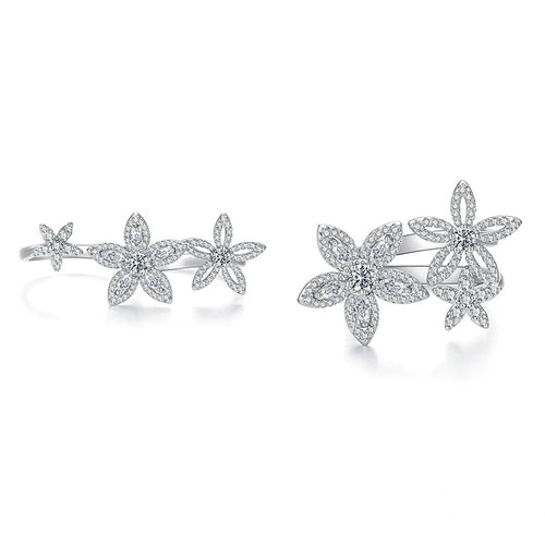 A pair of silver-toned flower cluster rings shown on a white background, labeled 'Open' and 'Close' to demonstrate the setting. The rings are paved with small clear stones.