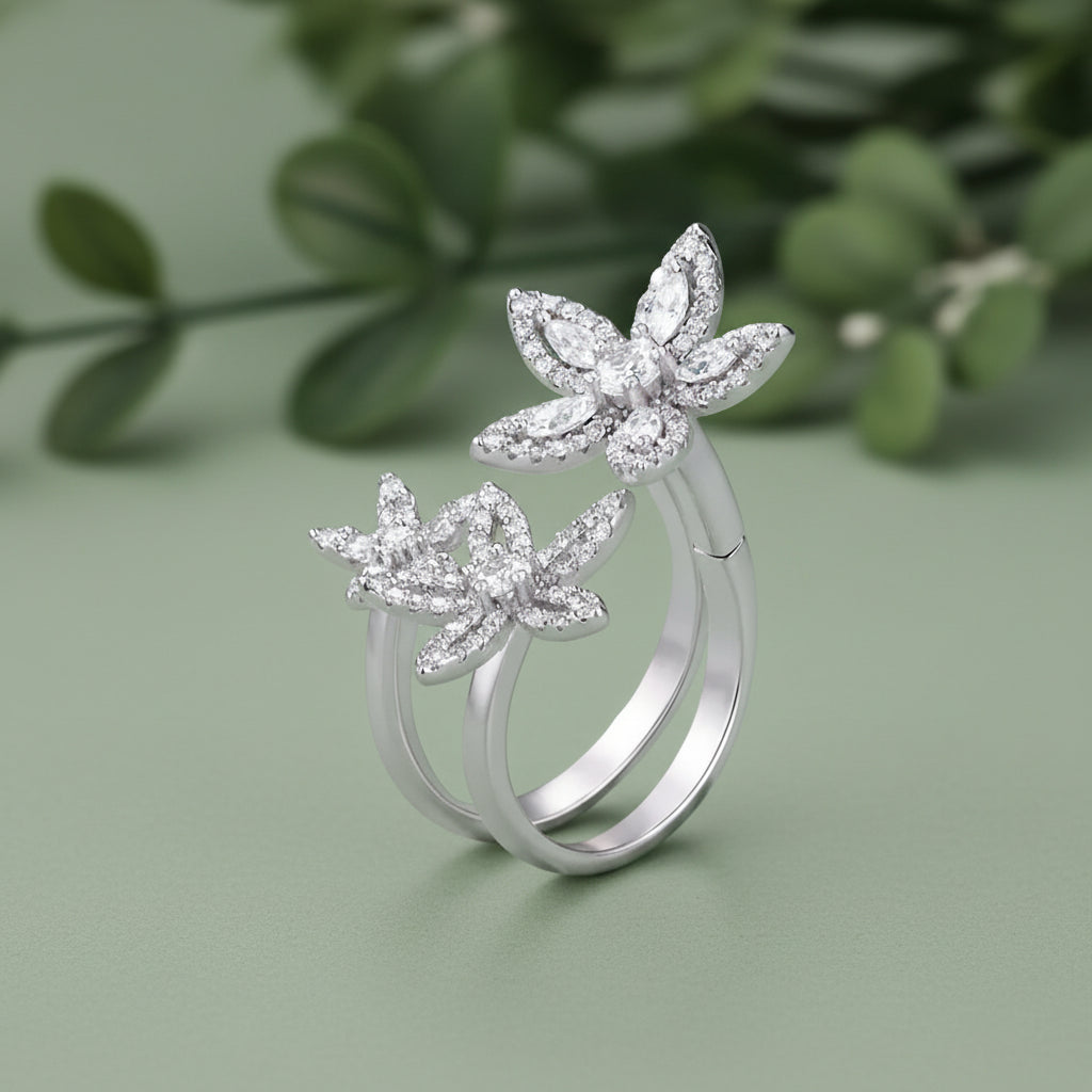Sterling silver butterfly ring set with clear marquise and round stones, featuring two interlocking butterfly designs on a mint green background with a 925 sterling silver ring.