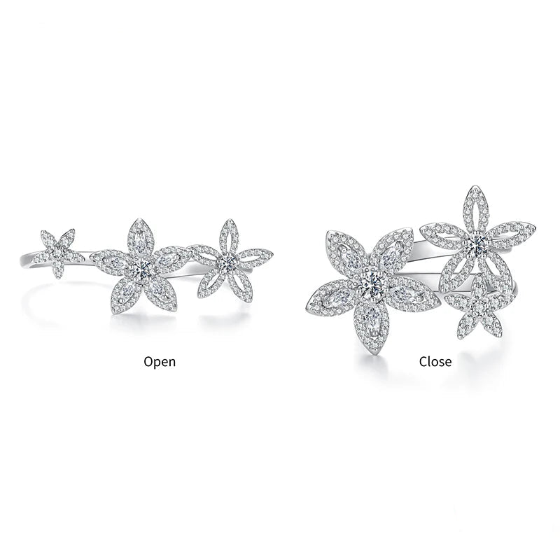 Sterling silver flower cluster ring shown in two views: open and close. The ring features three silver flower motifs paved with clear stones, displayed on a clean white background.