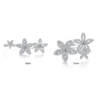Sterling silver flower cluster ring shown in two views: open and close. The ring features three silver flower motifs paved with clear stones, displayed on a clean white background.
