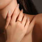 Close-up of a hand wearing a ring with a blurred background