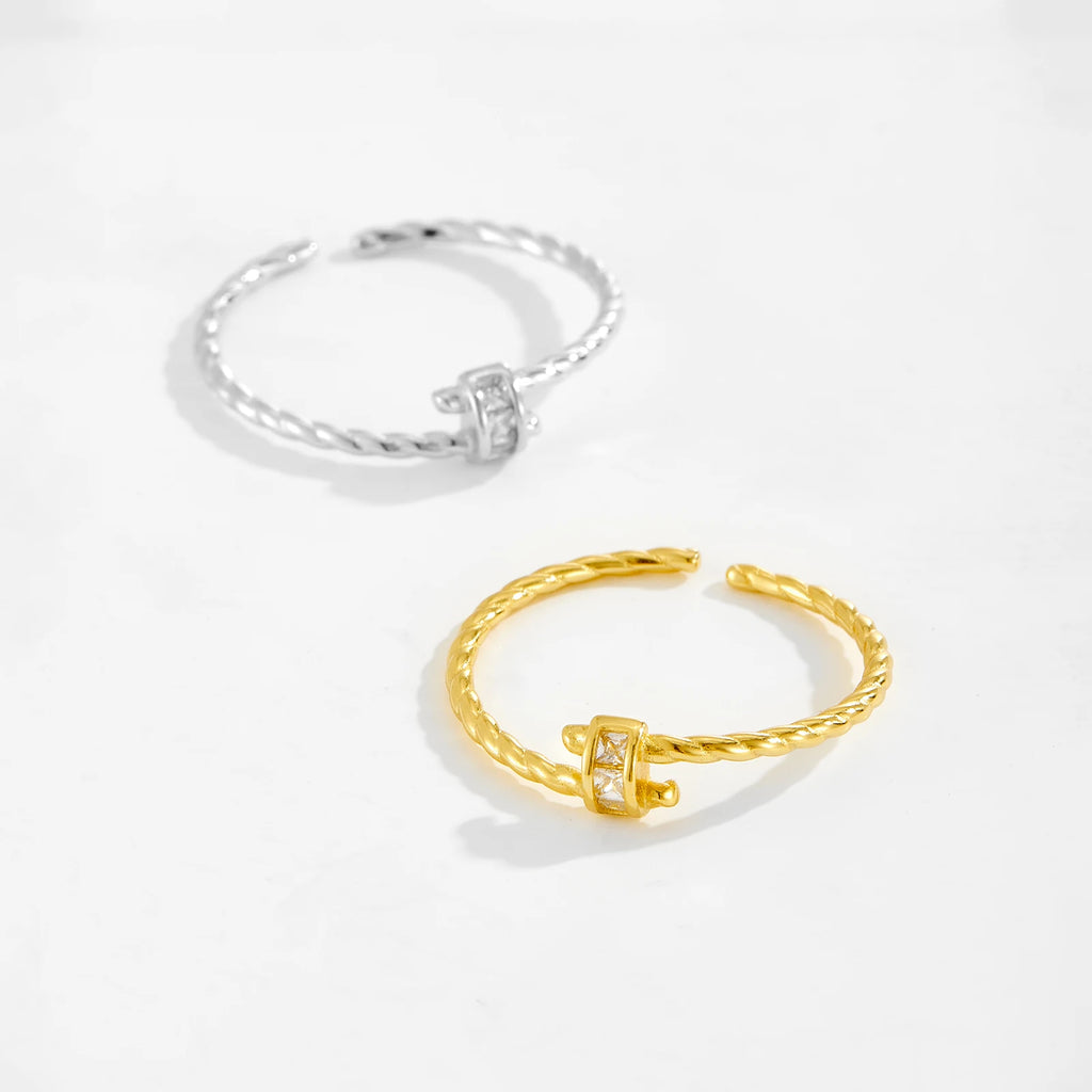 Gold and silver rings on a light gray background