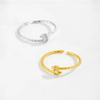 Gold and silver rings on a light gray background