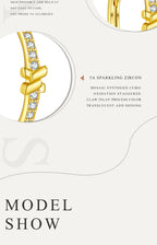 Gold earring with zircon stones on a white background