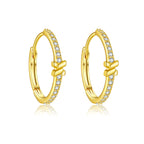 Gold hoop earrings with small diamonds on a white background
