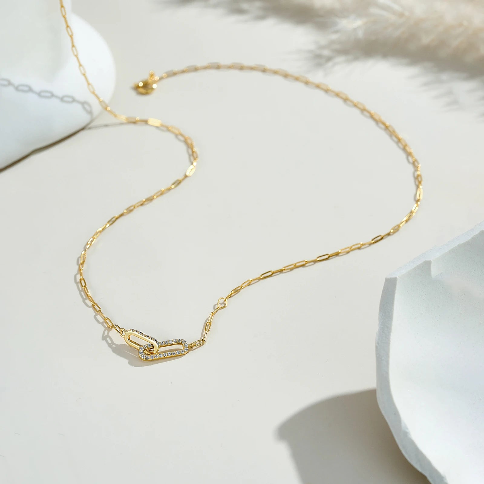 Gold necklace on a white surface