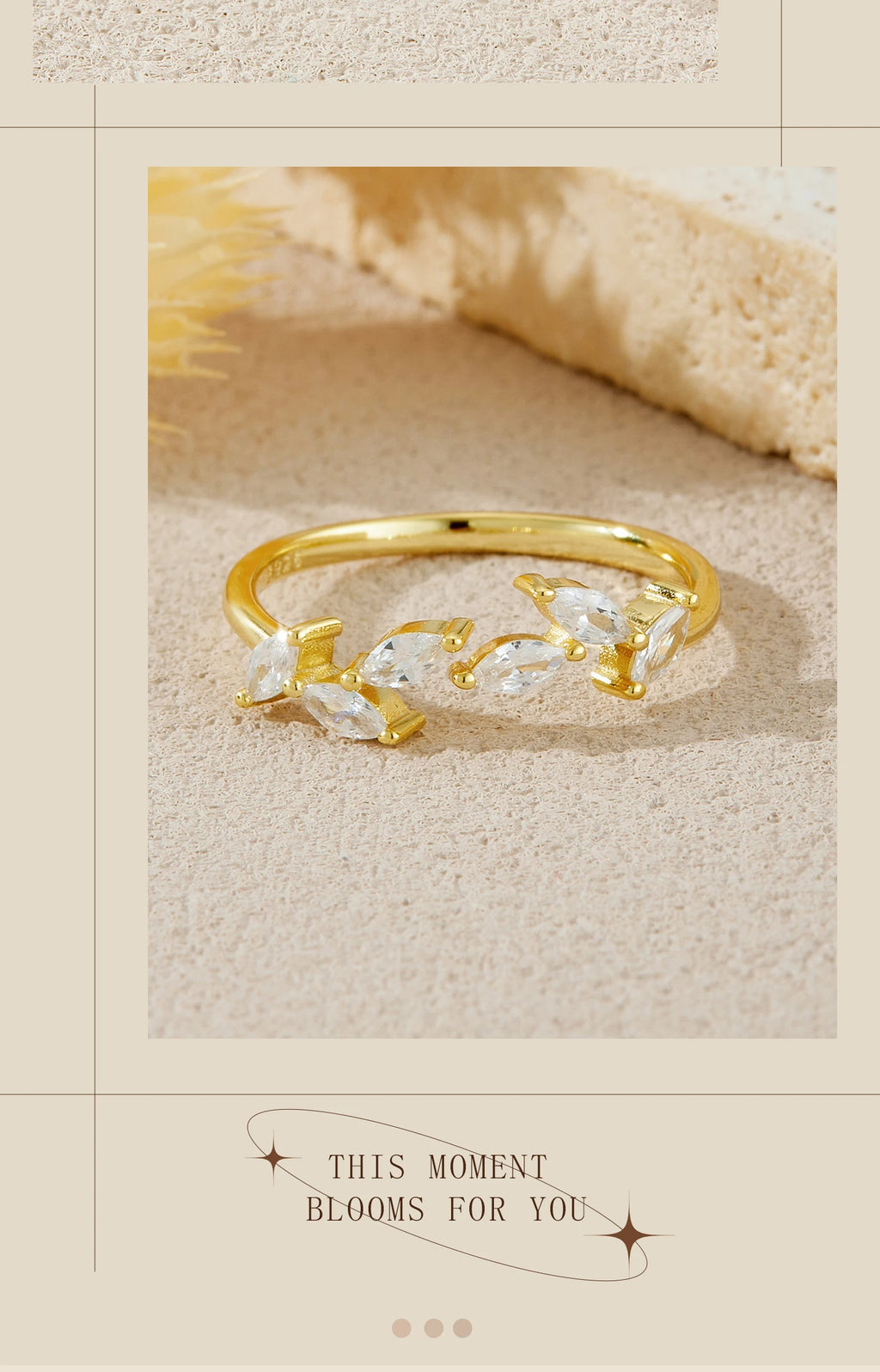 Gold ring with floral design on a textured beige surface