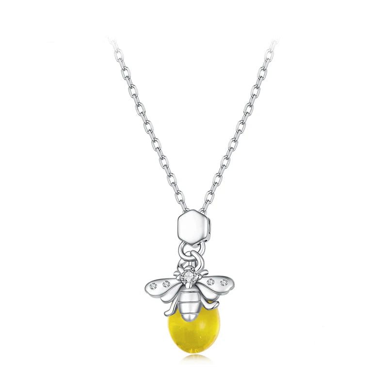A sterling silver bee pendant necklace with a yellow bead and clear rhinestones, shown on a white background.