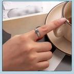 Hand with a ring holding a teacup, with a light blue border