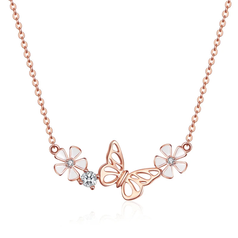 Rose gold butterfly and flower necklace on a white background