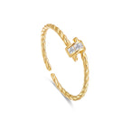 Twisted Gold ring with diamond accents on a white background